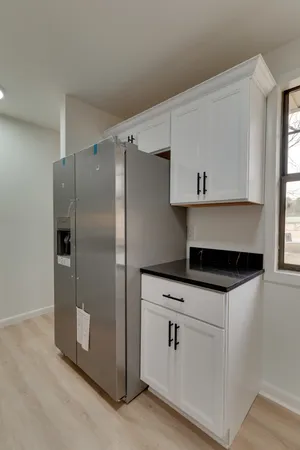 a kitchen with white cabinets and white stainless steel appliances
