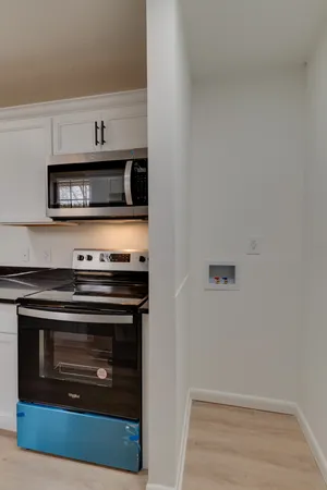a kitchen with cabinets and steel stainless steel appliances