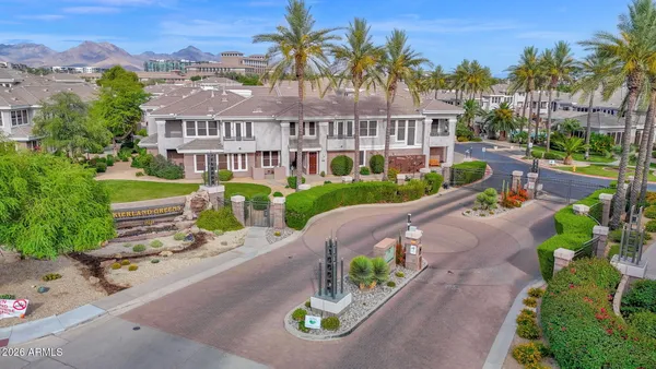an aerial view of a house with a garden and lake view