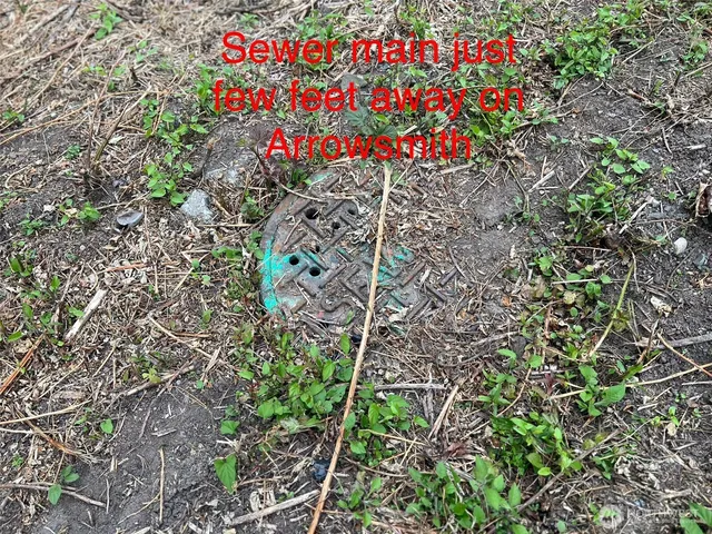 a sign of golf club on a wall under a tree