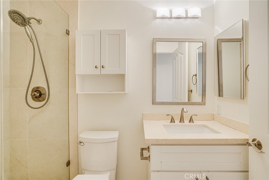 49 East Yale Loop, Unit 26 Irvine, CA 92604 - Photo 25 of 63 a bathroom with a sink a toilet and a mirror