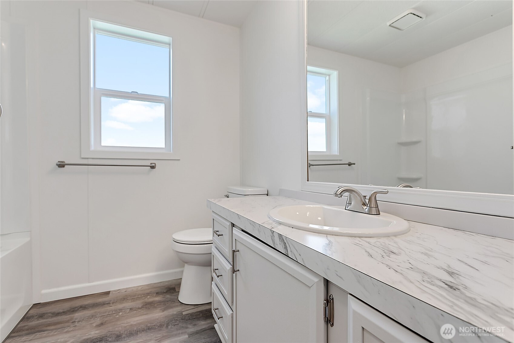 921 Autumn Lane, Unit 243 Bellingham, WA 98229 - Photo 12 of 24 a bathroom with a granite countertop toilet a sink and a mirror