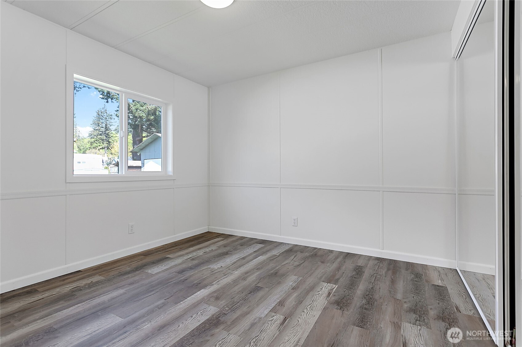 921 Autumn Lane, Unit 243 Bellingham, WA 98229 - Photo 13 of 24 wooden floor in an empty room with a window