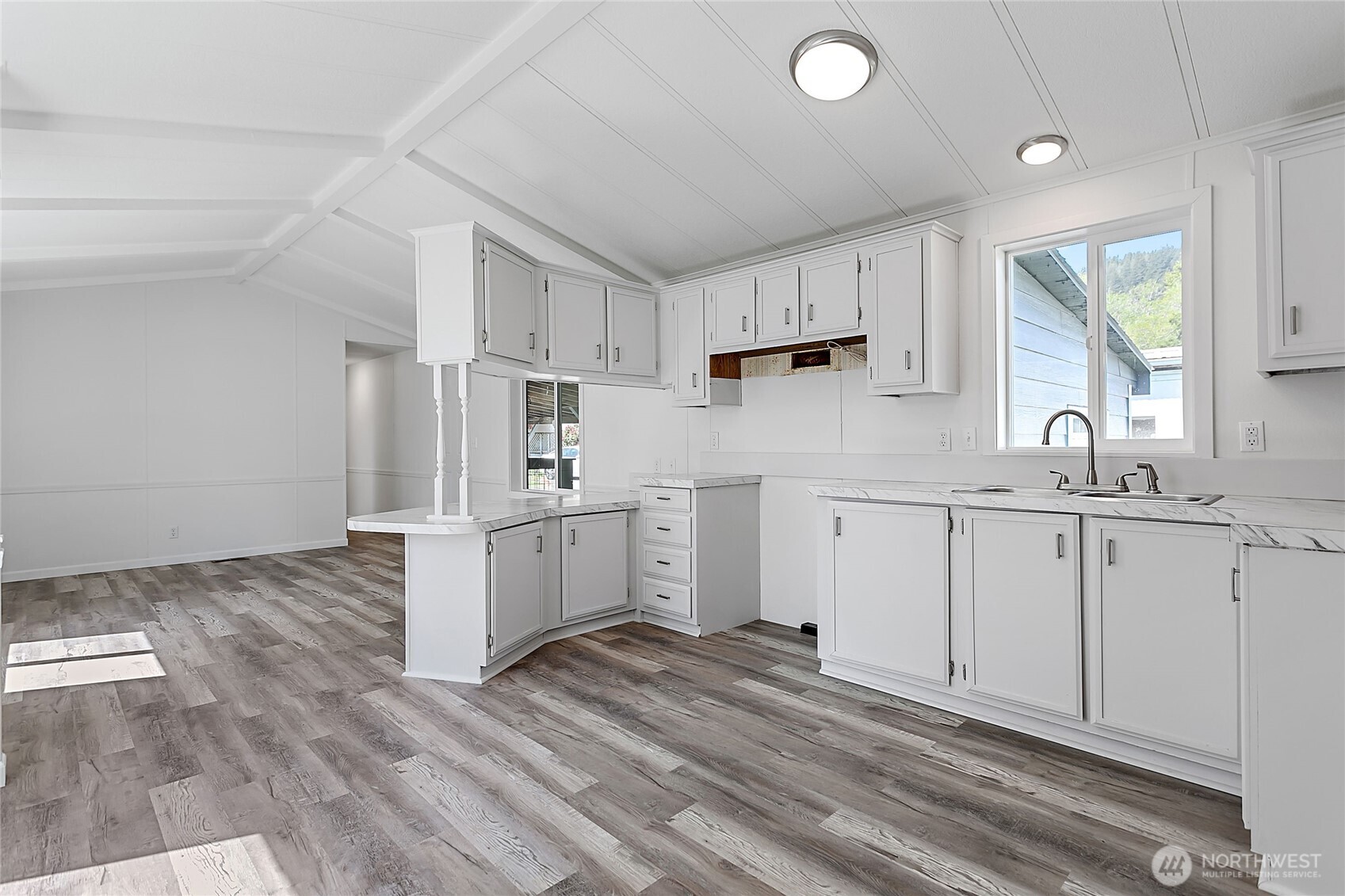921 Autumn Lane, Unit 243 Bellingham, WA 98229 - Photo 8 of 24 a kitchen with white cabinets and white appliances