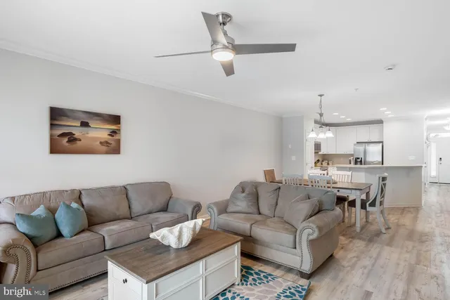 a kitchen with kitchen island a wooden floor and white cabinets