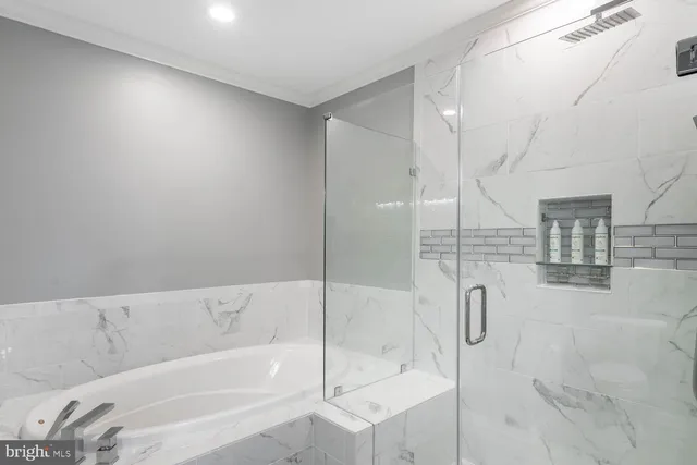 a bedroom with a bed and a refrigerator