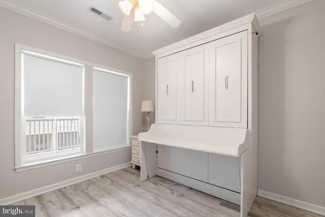a view of a livingroom with wooden floor and cabinet