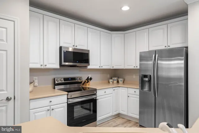 a kitchen with a refrigerator stove and microwave