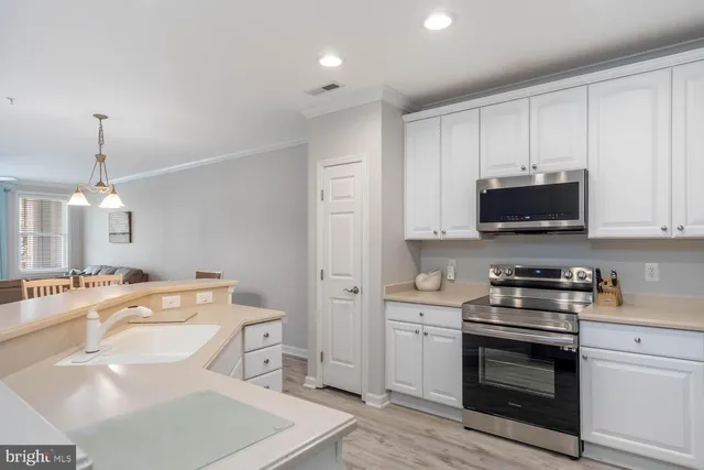a kitchen with a sink stove and microwave