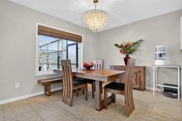 a view of a dining room with furniture and chandelier