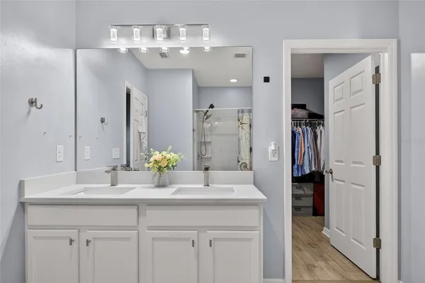 a bathroom with a sink double vanity and shower