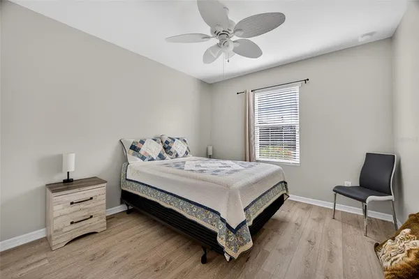 a bedroom with a bed and a chair