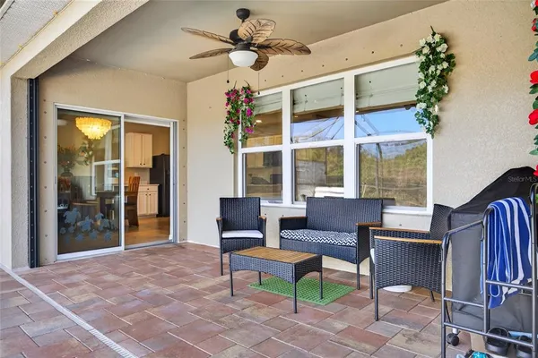a living room with furniture and a floor to ceiling window