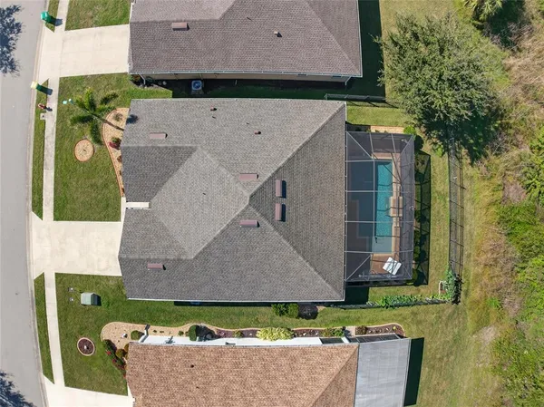 an aerial view of a house with a yard
