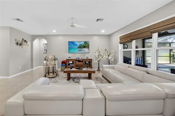 a living room with furniture and large window