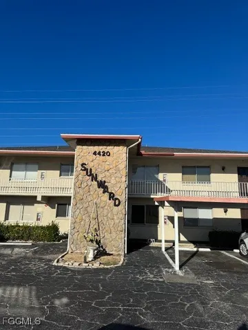 a view of a bedroom with a bed and a table