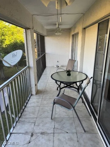 a view of a hallway with furniture and a window