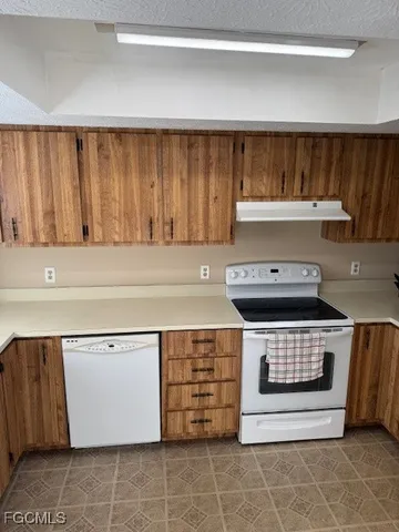 a stove top oven sitting inside of a kitchen