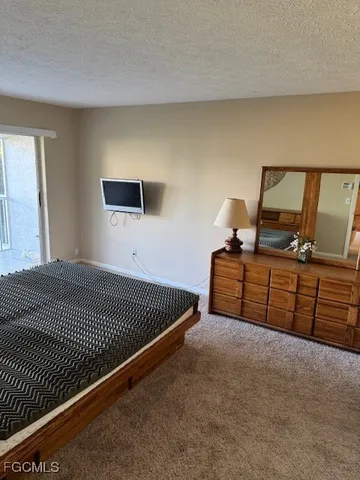 a bedroom with a bed and dresser