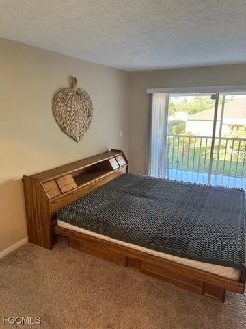 a view of room with a bed and a chandelier