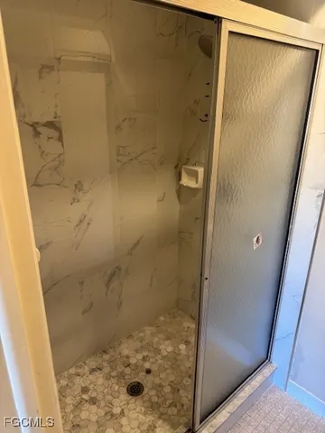 a bathroom with a glass shower door
