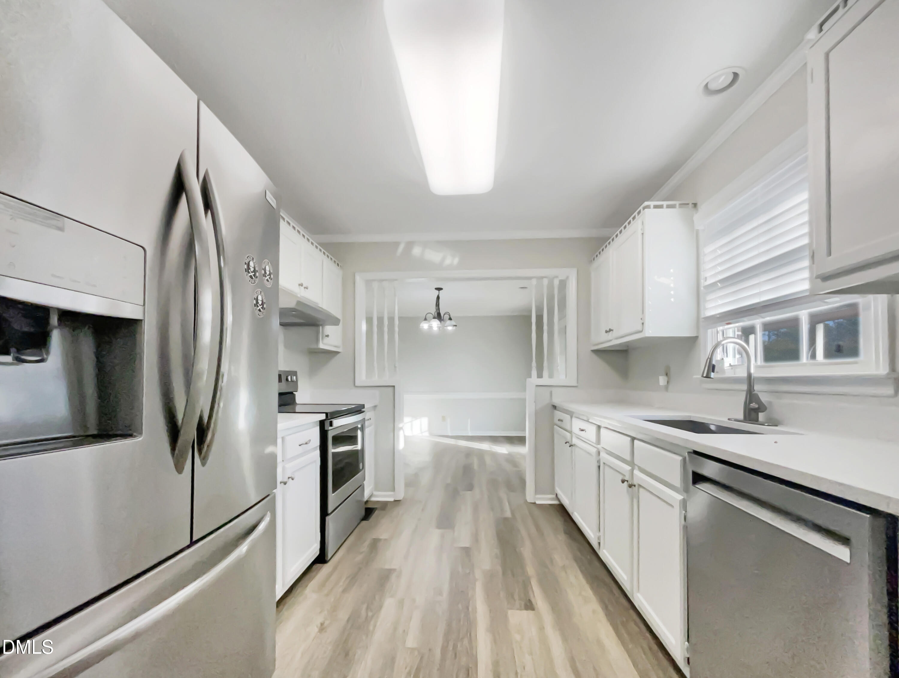 3257 Alforodo Street Fayetteville, NC 28306 - Photo 3 of 18 a kitchen with stainless steel appliances a sink stove and refrigerator