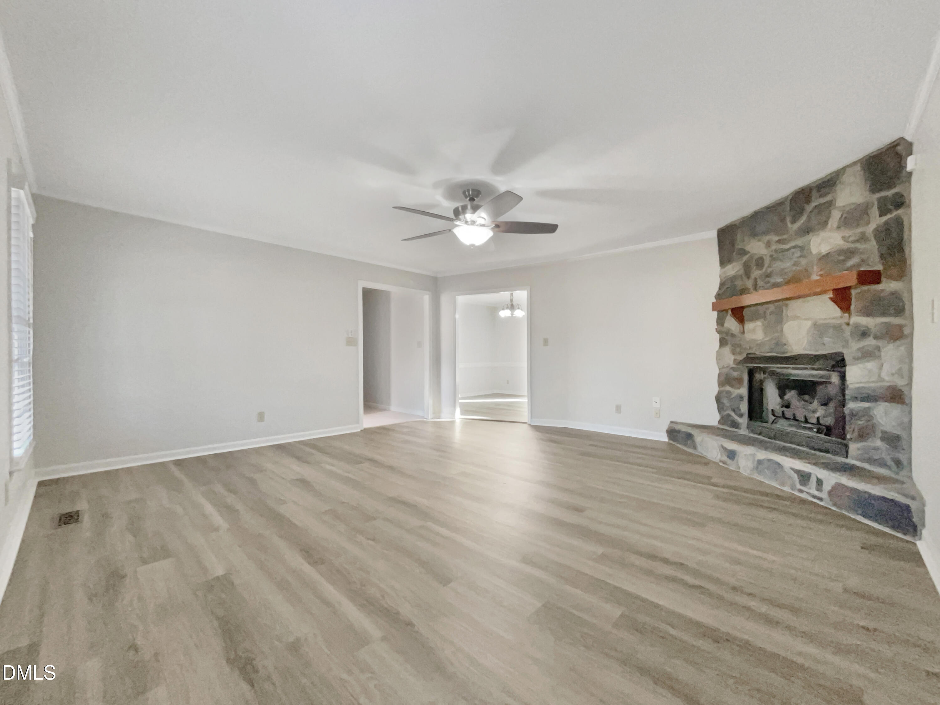 3257 Alforodo Street Fayetteville, NC 28306 - Photo 5 of 18 a view of an empty room with wooden floor fireplace and a window
