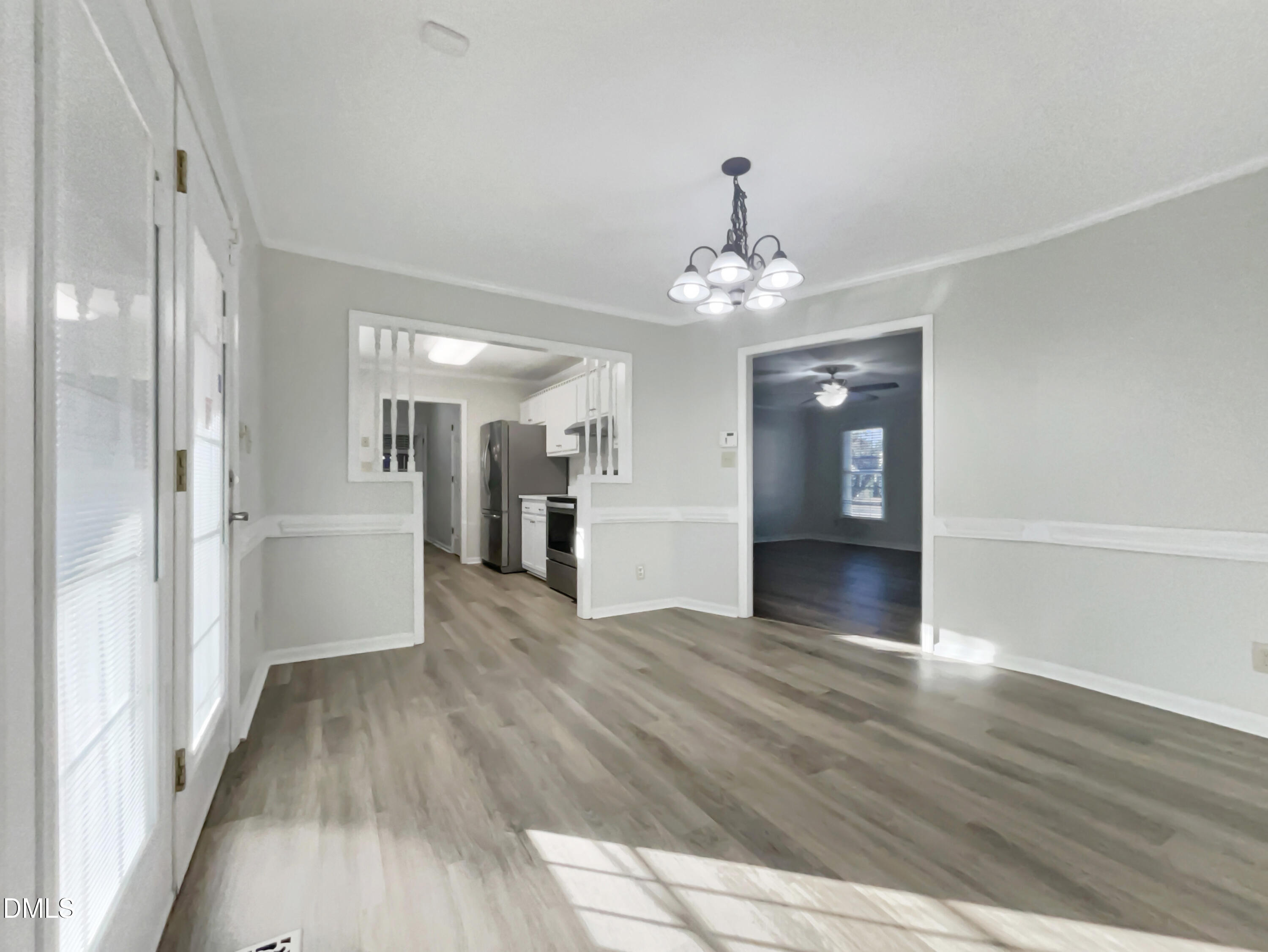 3257 Alforodo Street Fayetteville, NC 28306 - Photo 6 of 18 a view of a hallway with wooden floor and a kitchen