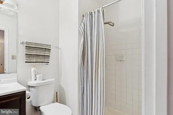 a white toilet sitting next to a bathroom sink