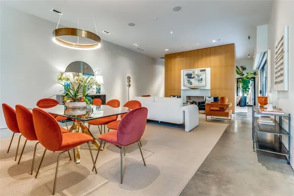 a living room with furniture a chandelier and a large mirror