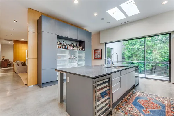 a kitchen with kitchen island a large window in it