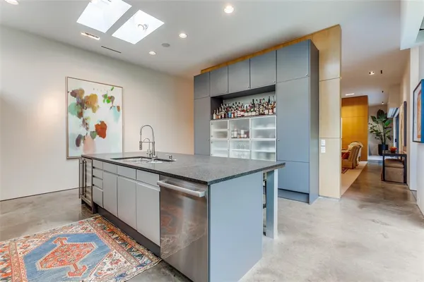 a view of kitchen island with stainless steel appliances granite countertop lots of counter top space