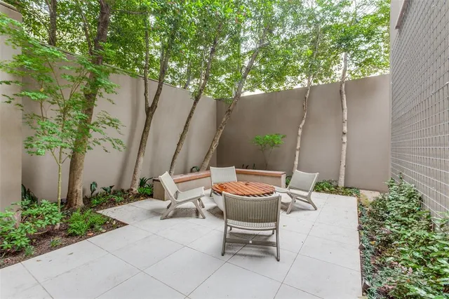 a backyard of a house with table and chairs