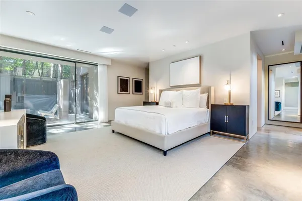 a bedroom with a bed and a couch