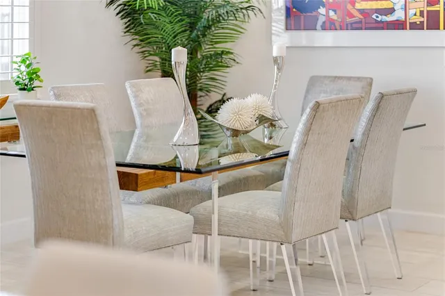a room with stainless steel appliances kitchen island granite countertop furniture and a potted plant