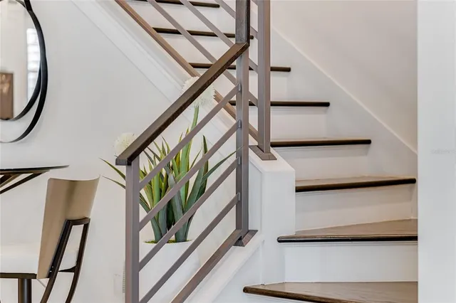 a bed room with a bed and a painting on the wall