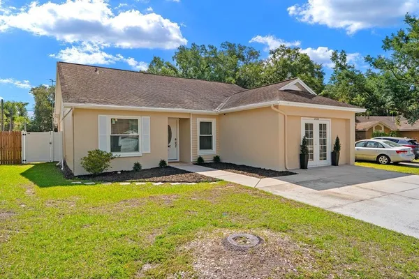 a view of a house with a backyard and a garden
