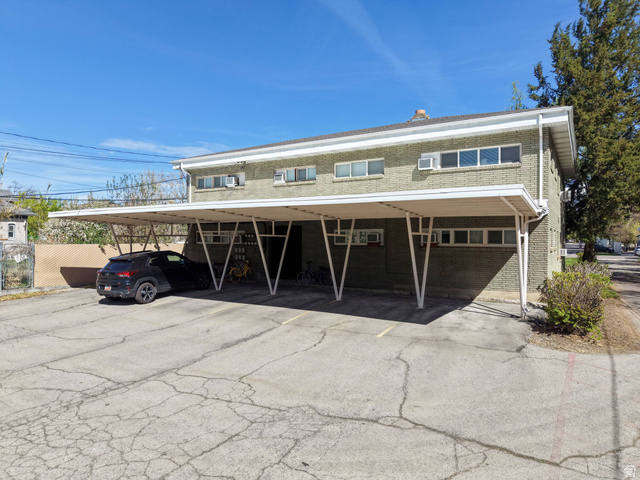 550 100 North Provo, UT 84606 - Photo 6 of 7 Exterior brick building with multiple windows, featuring a prominent covered parking structure