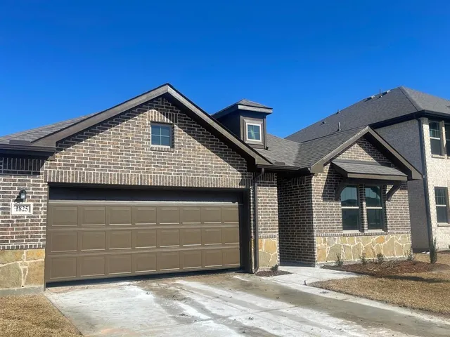 a front view of a house with a garage