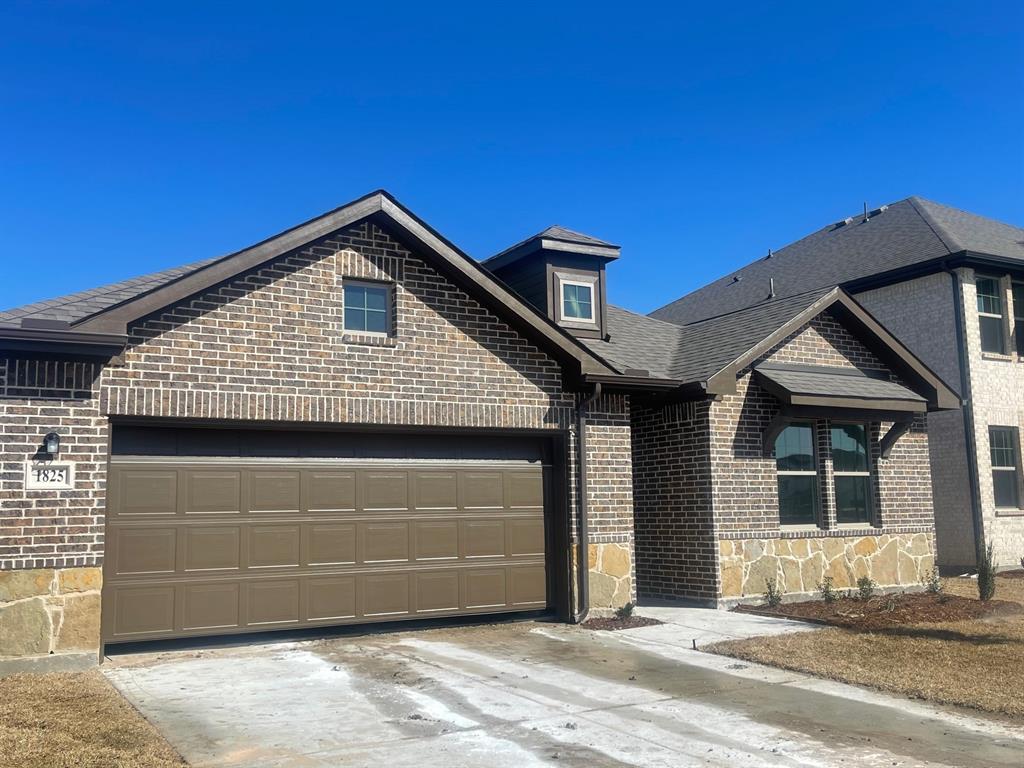 a front view of a house with a garage