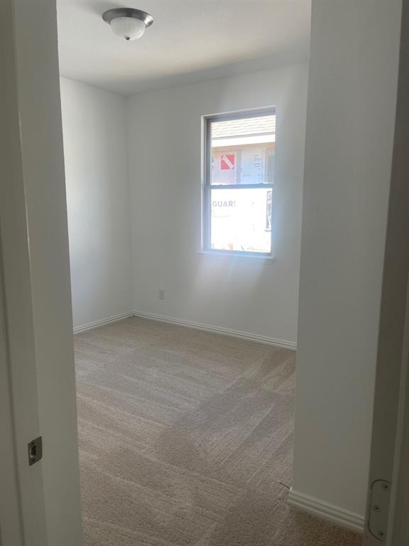 1825 Plymouth Drive Princeton, TX 75407 - Photo 13 of 23 an empty room with a window