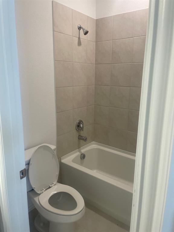 1825 Plymouth Drive Princeton, TX 75407 - Photo 14 of 23 a white toilet sitting next to a bath tub
