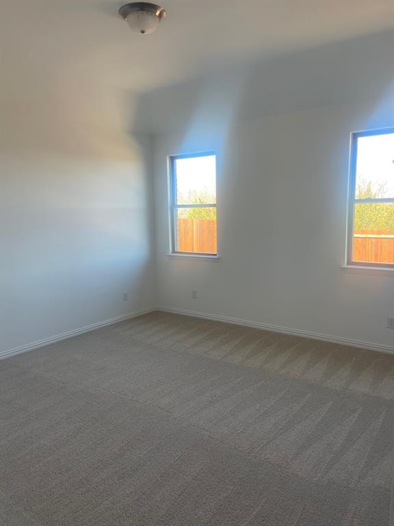1825 Plymouth Drive Princeton, TX 75407 - Photo 19 of 23 an empty room with a window