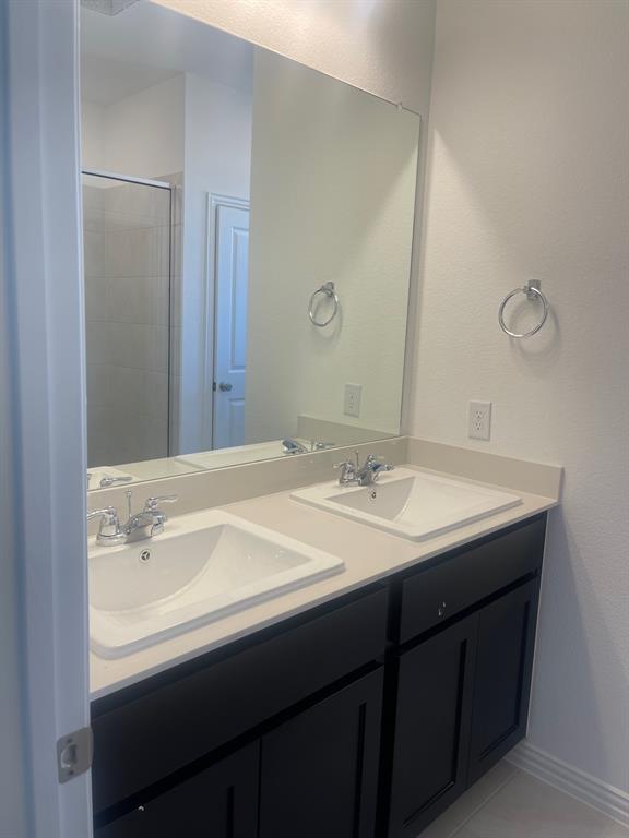 1825 Plymouth Drive Princeton, TX 75407 - Photo 20 of 23 a bathroom with a sink and a mirror
