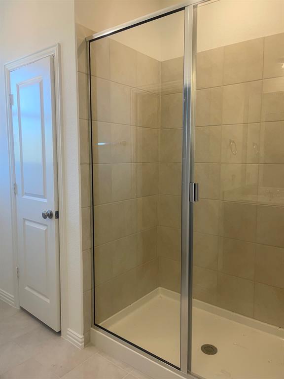 1825 Plymouth Drive Princeton, TX 75407 - Photo 21 of 23 a bathroom with a glass shower door