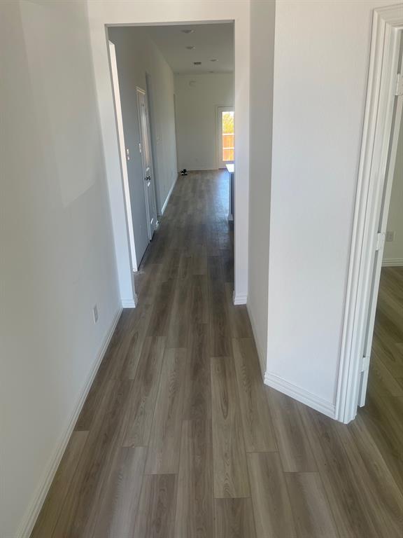 1825 Plymouth Drive Princeton, TX 75407 - Photo 4 of 23 a view of a hallway with wooden floor