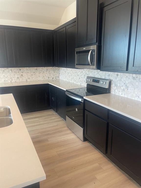 1825 Plymouth Drive Princeton, TX 75407 - Photo 7 of 23 a kitchen with a sink and cabinets