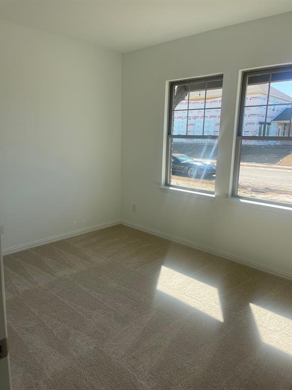 1825 Plymouth Drive Princeton, TX 75407 - Photo 10 of 23 an empty room with a window