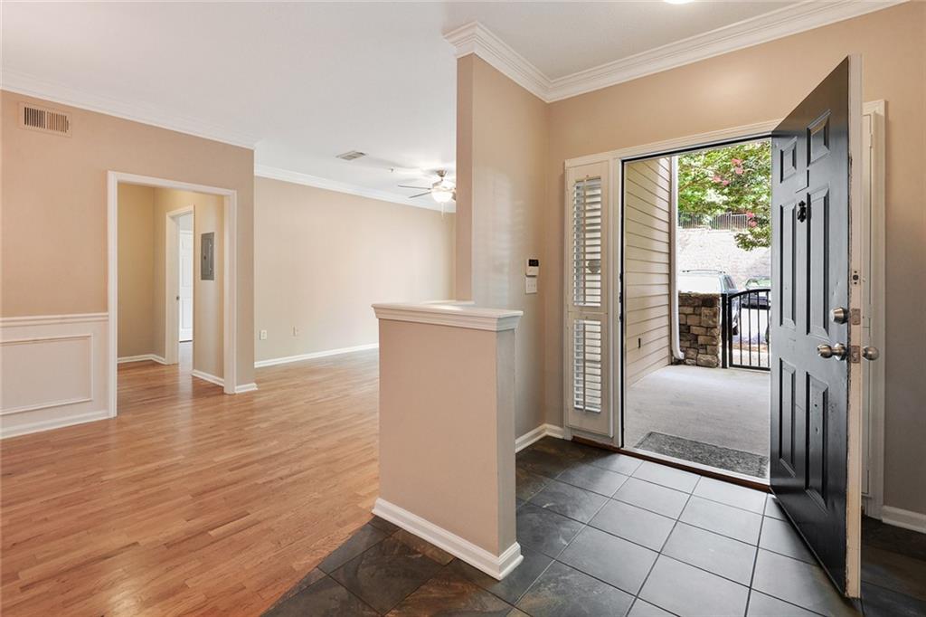 2400 Cumberland Parkway Southeast, Unit 611 Atlanta, GA 30339 - Photo 17 of 26 a view of a kitchen with a refrigerator cabinets and a wooden floor