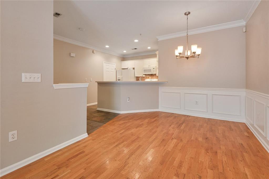 2400 Cumberland Parkway Southeast, Unit 611 Atlanta, GA 30339 - Photo 18 of 26 a view of a kitchen with kitchen island wooden floor center island and stainless steel appliances